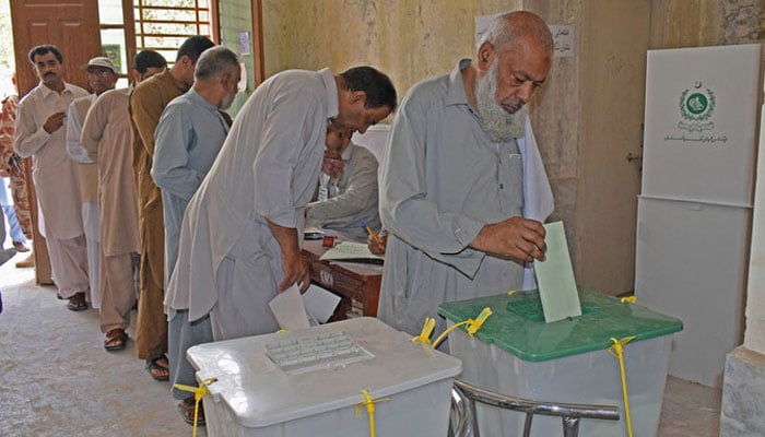 A Pakistani man casts his vote at a polling station during Pakistans general election in Quetta. — AFP/File