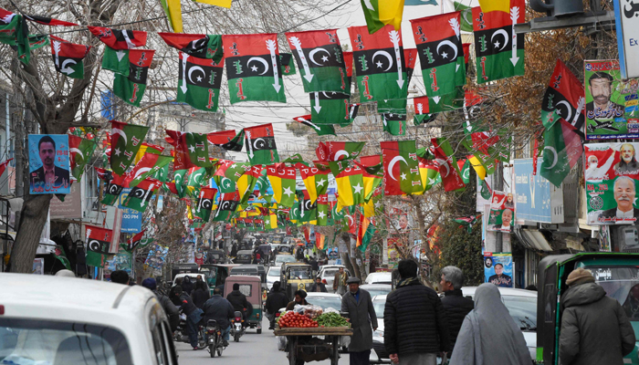 This photo taken on February 3, 2024, shows a street festooned with flags of political parties ahead of Pakistan´s national elections, in Quetta. — AFP