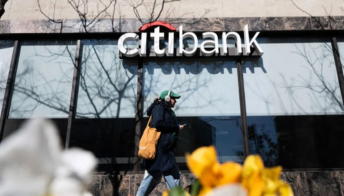 A woman walks past a Citibank branch in Washington in March. —.AFP