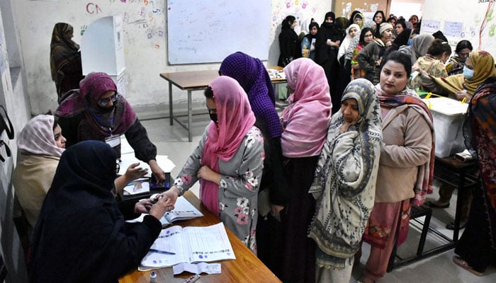A large number of women in queue to cast their vote outside a polling station during the General Election 2024 on February 8, 2024. — APP
