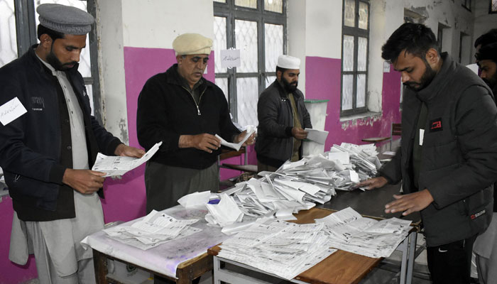 Members of the polling staff started counting the votes after the polls closed for parliamentary elections in Lahore on February 8, 2024. — Online