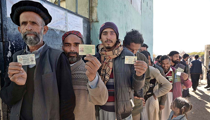People standing in queue in front of polling station to cast their vote during General Election-2024 on February 8, 2024. — APP