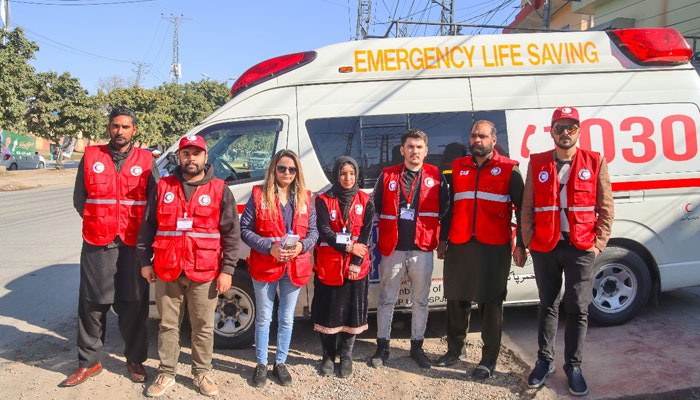 PRCS first aid personnel stand nearby the ambulance on February 8, 2024. — Facebook/Pakistan Red Crescent