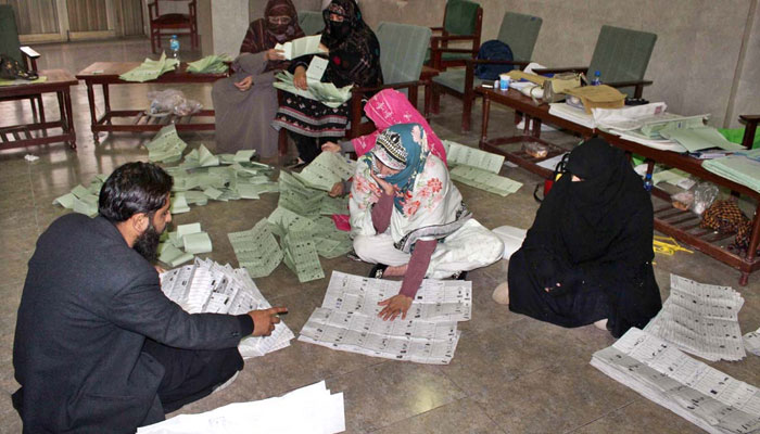 Polling staff counting votes in a polling station at Postal Colony during General Elections 2024 on February 8, 2024. — APP