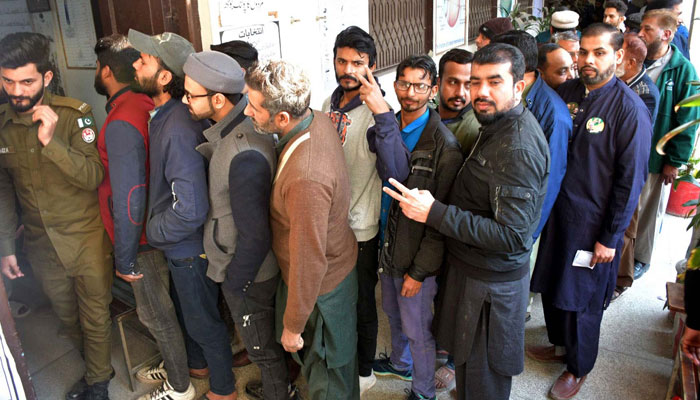 Voters are in queue waiting to cast their votes at a polling station during General Election 2024, in Lahore on February 8, 2024. — PPI