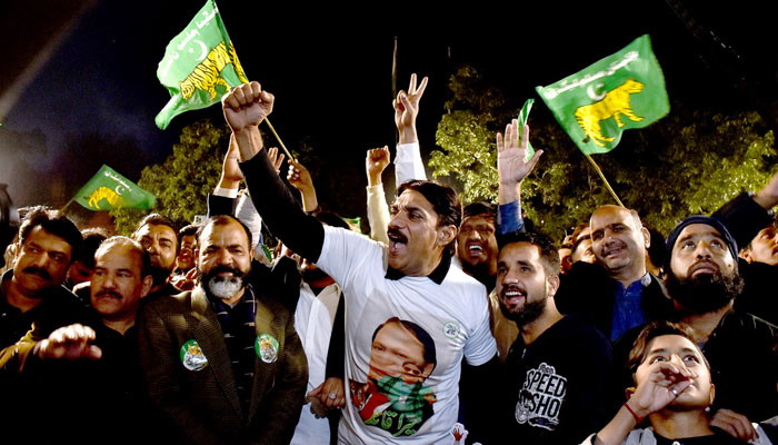 Supporters of Former PM Nawaz Sharifs party Pakistan Muslim League-N dance to celebrate their party victory at Model Town on February 9, 2024. — APP
