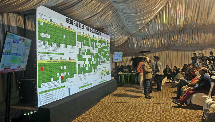 Journalists stand in front of a screen showing results of the countrys parliamentary elections at the Pakistan Election Commission office, in the Federal Capital on February 9, 2024. — Online