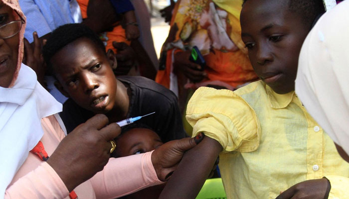 A young Sudanese receives a vaccine shot in Sudans eastern state of Gedaref during a vaccination campaign against the measles and rubella virus on January 22, 2024, — AFP