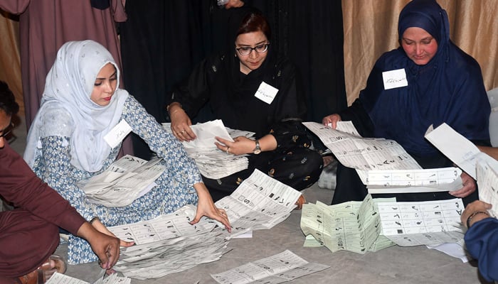 Members of polling staff start counting the votes after the polls closed for parliamentary elections, in the Provincial Capital on February 8, 2024. — Online