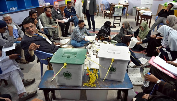Polling staff count votes in a polling station during General Elections 2024 on February 8, 2024. — APP