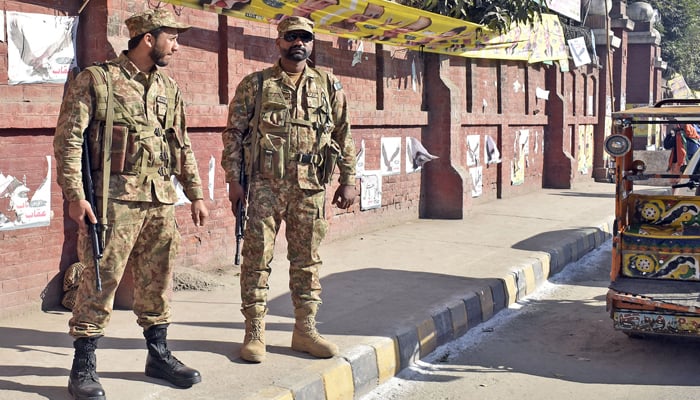 Park Army soldiers stand alert outside a polling station during the countrys parliamentary elections on February 8, 2024. — Online