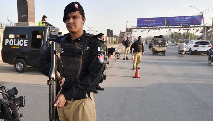 Police personnel stand alert during a security alert in Karachi on February 2, 2024. — INP