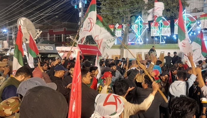 Muttahida Qaumi Movement-Pakistan (MQM-P) supporters wave party flags on February 9, 2024. —Facebook/Syed Mustafa Kamal