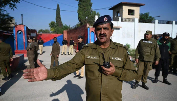 Police officials stand guard outside the Adiala Jail, in Rawalpindi on October 23, 2023. — AFP