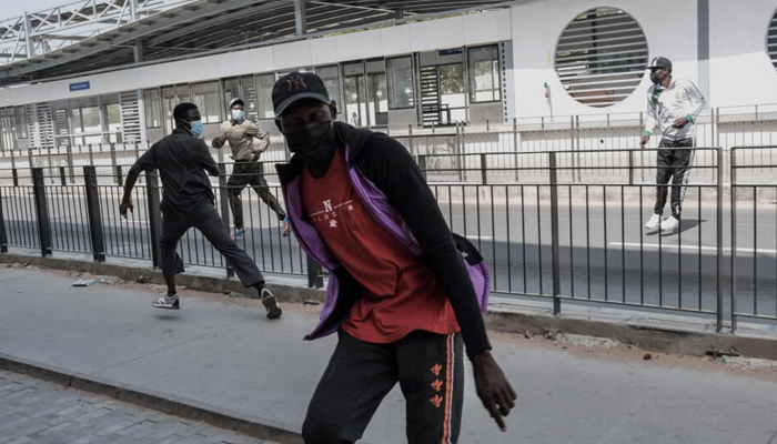 Protestors react during clashes with police in Dakar on February 9, 2024. — AFP