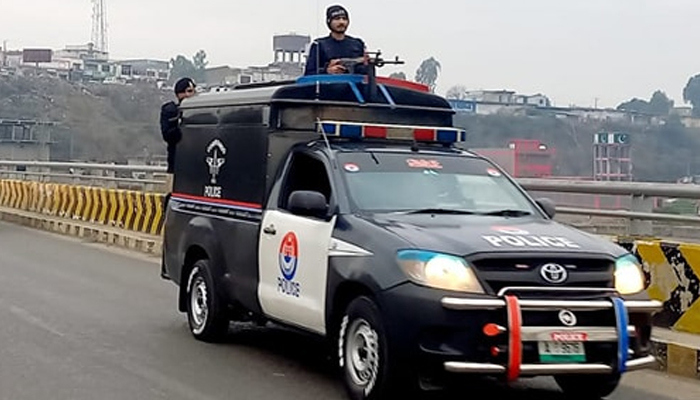 Police personnel in the police vehicle during the flag march at Abbottabad on February 4, 2024. — Facebook/Khyber Pakhtunkhwa Police