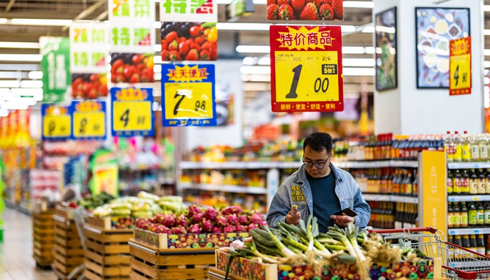 A consumer shops at a supermarket in Anshun, southwest Chinas Guizhou Province, April 11, 2023. — Xinhua