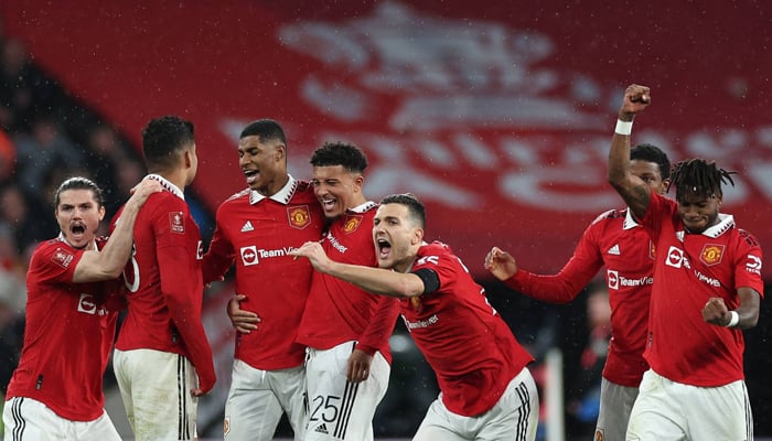 Manchester Uniteds players celebrate during a match. — AFP/File