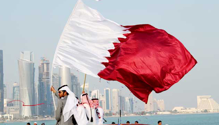 A person holds a Qatari flag. — AFP/File