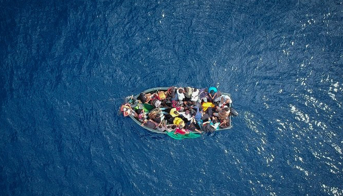 This aerial view shows migrants on a boat. — AFP/File
