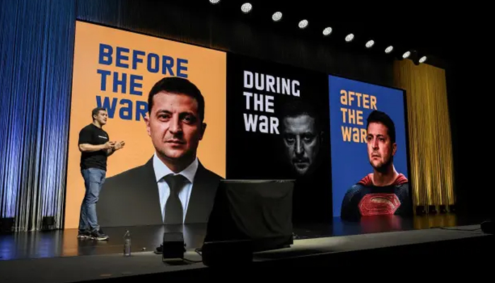 Ukrainian Minister for Digitalisation, Mykhailo Fedorov delivers a speech next to pictures of Ukraine’s President Volodymyr Zelensky during a two-day International conference on reconstruction of Ukraine, in Lugano on July 4, 2022. — AFP