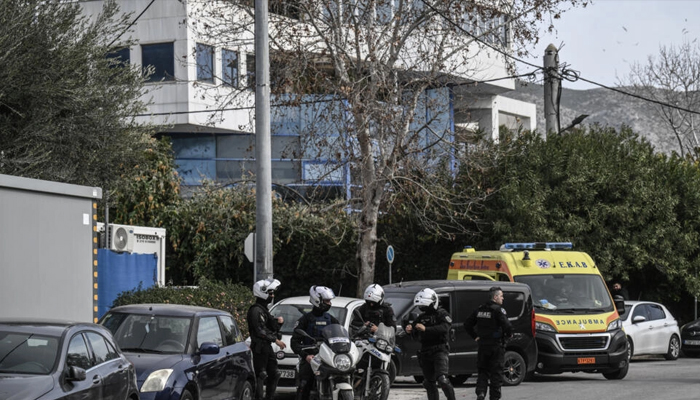 This image shows Greek police officials standing on a street. — AFP/File