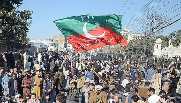 PTI workers are protesting by blocking the road against the ECP, PTI workers protested against rigging in front of Faqirabad Police Station, Peshawar on February 9, 2024. — INP