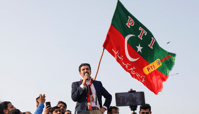 PTI leader Sher Afzal Marwat addresses participants in the rally near Seaview on Sunday. — AFP