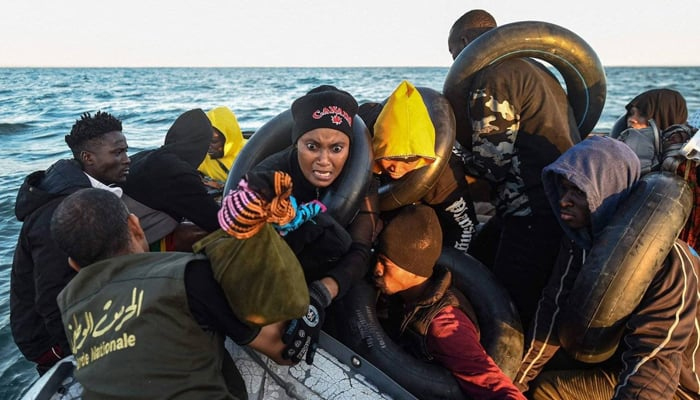 This image shows migrants on a small boat. — AFP/File