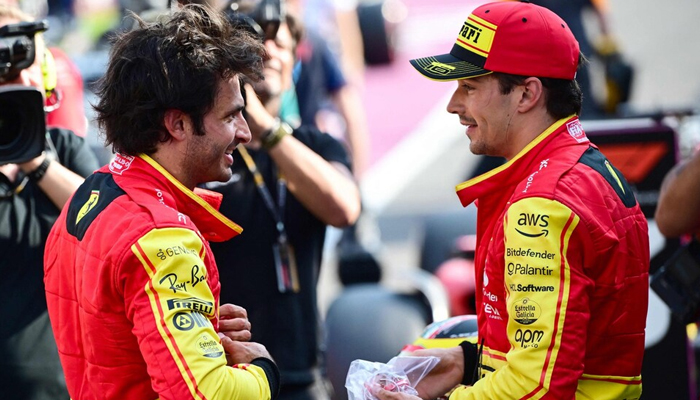 Charles Leclerc and Carlos Sainz (R) celebrate after qualifying first and third on the grid. — AFP/File