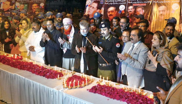 In this image Police officials and civil society members praying for the martyrs of the blast in front of the Punjab Assembly. — Online/File