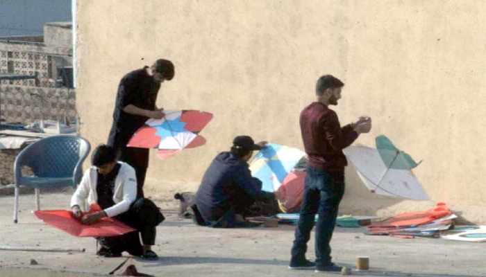 People can be seen while preparing for the kite fly event. — APP/File