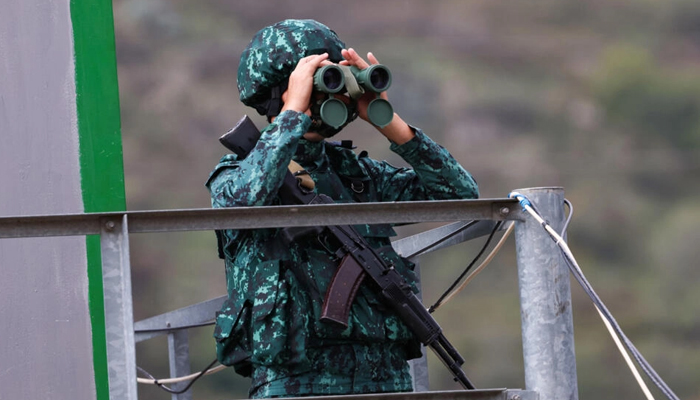 An Azerbaijani soldier uses binoculars in Lachin on September 26, 2023. — AFP