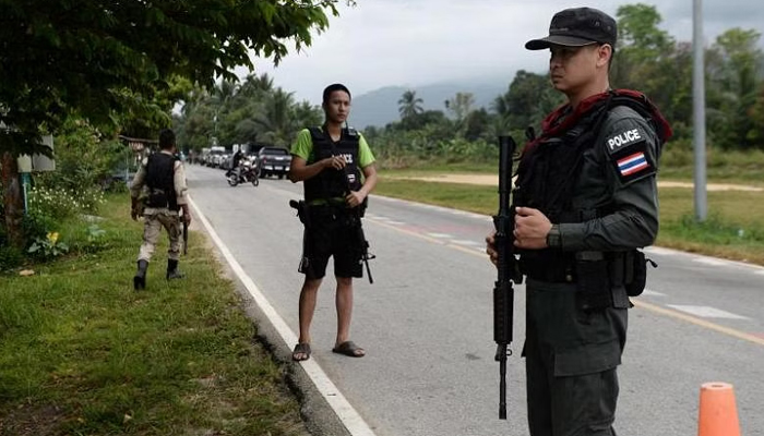 Armed Thai police personnel secure an area in the restive southern Thailand province of Narathiwat. — AFP/File