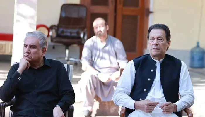 This photograph released on October 24, 2023, shows former premier Imran Khan (R) and Vice Chairman PTI Shah Mahmood Qureshi while listening to party members. — Facebook/Imran Khan