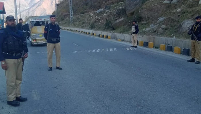 Swat police officials stand on a road in this image on December 8, 2023. — Facebook/Swat Police