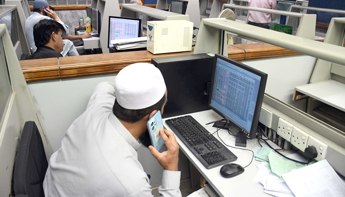 Stock brokers watch share prices during a trading session at the Pakistan Stock Exchange (PSX) in the Provincial Capital on February 13, 2024. — Online