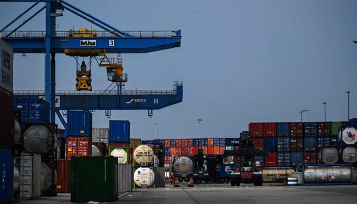 Containers are loaded onto trucks at the seaport terminal DIT Duisburg Intermodal Terminal at the Duisburg harbour, on July 13, 2023. — AFP