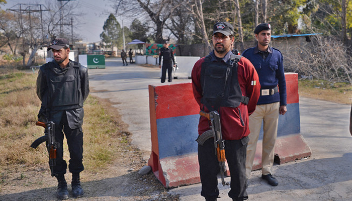 Pakistani policemen stand guard outside the central jail in Haripur. — AFP/File
