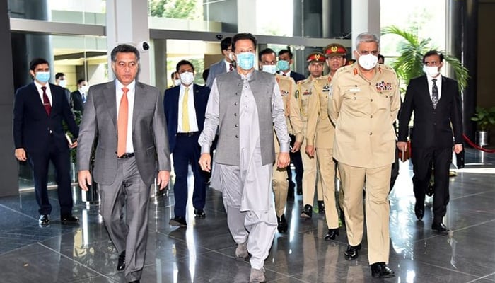 The then-ISI chief Lt Gen Faiz Hameed (left) PM Imran Khan (center) Chief of the Army Staff General Qamar Javed Bajwa (right) enter ISI headquarters on May 24, 2021. — PMO