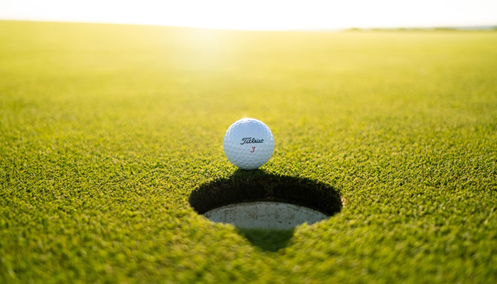A representational image of a golf ball in the field. — Unsplash
