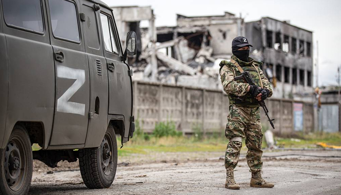 A Russian soldier stands near a military vehicle. — Tass/File