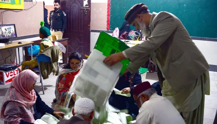 ECP workers are counting votes after polling at a polling station during General Elections 2024, held in Karachi on February 8, 2024. — PPI