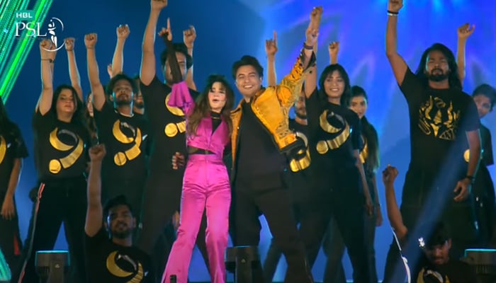 This screengrab shows renowned singers Ali Zafar and Aima Baig performing at the opening ceremony of Pakistan Super League (PSL) season nine at Gaddafi Stadium in Lahore on February 17, 2024. —Youtube/Pakistan Super League
