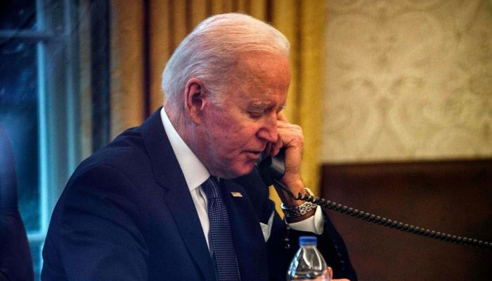 US President Joe Biden speaks on the phone in this image. — AFP