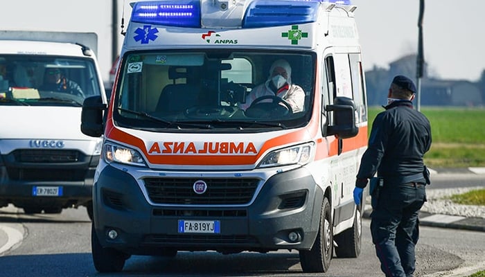An ambulance drives past a police checkpoint a few kilometers from the small town of Castiglione dAdda, southeast of Milan, Italy. — AFP/File