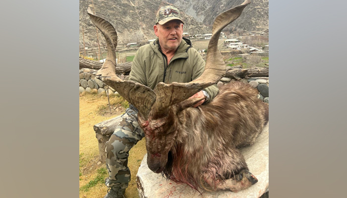 An American hunter Robert Myles Hall is pictured with a Kashmir  Markhor at the Gahirat-Golen community game reserve during the 3rd Trophy Hunting of Markhor in the ongoing season in Chitral on February 18, 2024. — Facebook/Chitral Wildlife Division