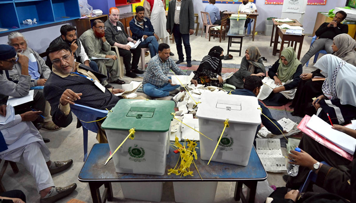 Polling staff count votes in a polling station during General Elections 2024 on February 8, 2024. — APP