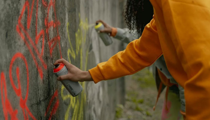 This representational image of people spraying paint. — AFP