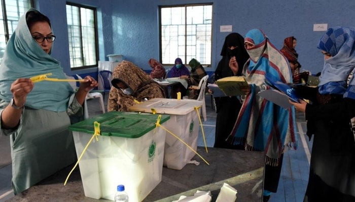 Polling staff open ballot boxes in presence of polling agents from various political parties as they start counting votes at the end of Pakistans national elections in Quetta on February 8, 2024. — AFP